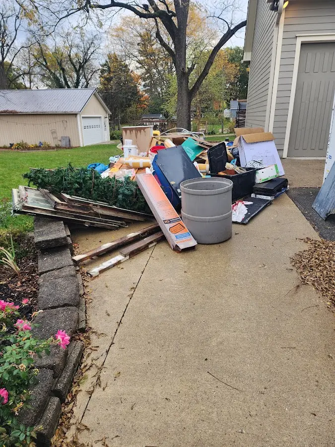 Dumpster being loaded with debris for 3 Yard Dumpster Rental in Millinocket